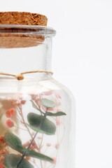 bouquet of dry flowers and potpourri in a glass jar on a white table. High quality photo