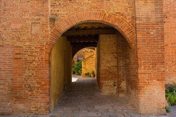 Fototapeta na wymiar A residential alley in the historic medieval village of Buonconvento, Siena Province, Tuscany, Italy 