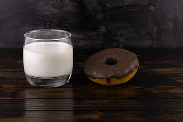 A glass of milk and a chocolate donut
