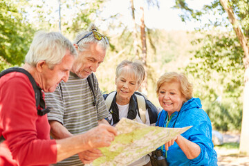 Group of active seniors with hiking map