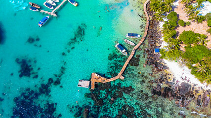 Aerial view of beautiful landscape, tourism boats, and people swimming on the sea and beach on May Rut island (a tranquil island with beautiful beach) in Phu Quoc, Kien Giang, Vietnam. © CravenA