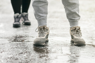 Pedestrians glide along the icy sidewalk. Winter ice on footpaths.