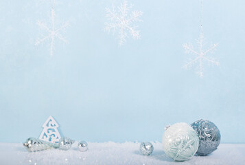 Christmas balls and toys silvery, snowflakes, snow, blue abstract background.