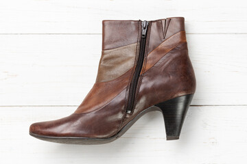 Women's autumn leather shoes on a white wooden table. Composition of clothes. Flatlay.