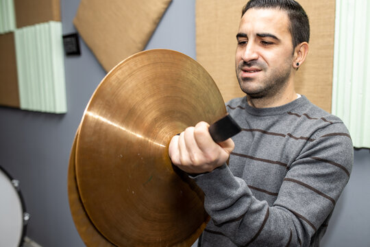 man playing musical instrument metal cymbals of orchestra