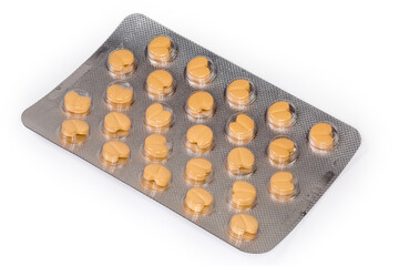 Blister pack with yellow heart shaped pills on white background