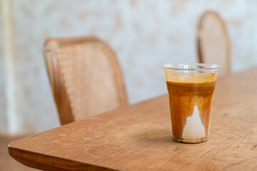 Specialty coffee menu called 'Dirty coffee' . Cold milk in the bottom with hot espresso shot on top