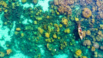 Aerial view of beautiful landscape, tourism boats, and people swimming on the sea and beach on May Rut island (a tranquil island with beautiful beach) in Phu Quoc, Kien Giang, Vietnam.