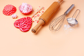 Baking romantic cookies for Valentine's Day. Rolling pin for dough, candy in the shape of a heart and flour