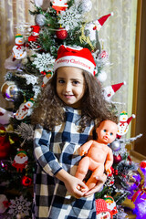 beautiful small girl with christmas tree