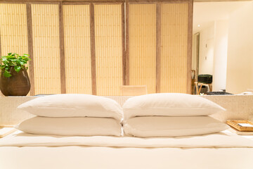 white pillows in luxury hotel resort bedroom