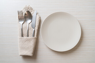 empty plate or dish with knife, fork and spoon