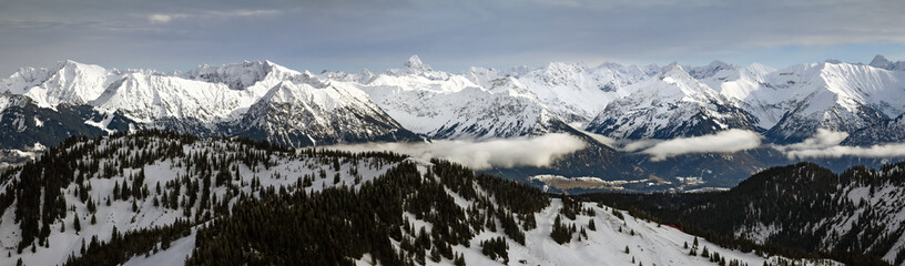 Dramatic snow covered mountains Landscape. Amazing Panoramic snowy winter landscape in Alps at...