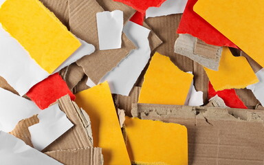 Torn blank cardboard and colorful paper pieces for recycling background and texture