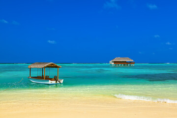 Boat and bungalow on Maldives island