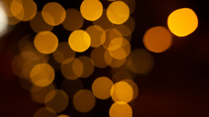 Abstract evening night shimmering bokeh background effect street outside near cafe restaurant. Defocused urban city life blur golden light bulbs garlands. Christmas New Year party holiday concept. 