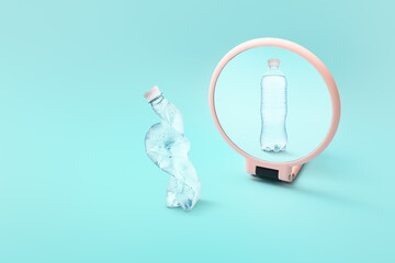 Crumpled plastic bottle looking at its reflection in mirror on color background