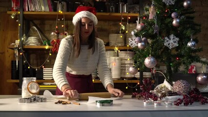 Vegan chef girl cooking sweets wearing santa hat with christmas decoration in christmas kitchen