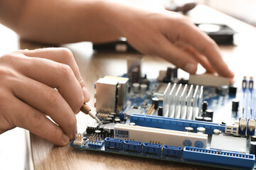 Technician repairing computer in service center, closeup