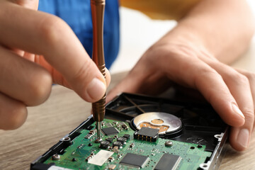 Technician repairing computer in service center, closeup