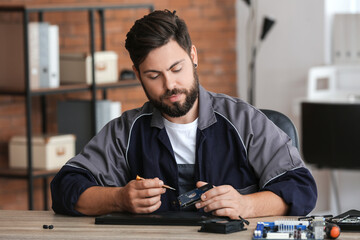 Technician repairing computer in service center