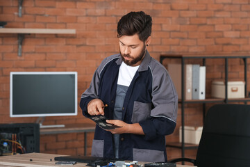 Technician repairing computer in service center