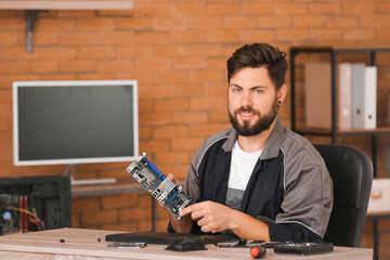Technician repairing computer in service center