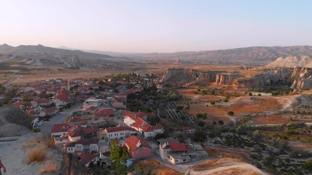 Aerial drone view of Cavusin village, Goreme, Cappadocia, Turkey. Tourist woman and tipical turkish village