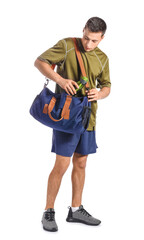 Young man with sports bag on white background