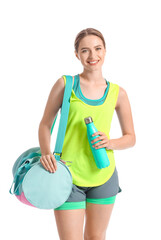 Young woman with sports bag on white background