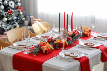 Beautiful table setting with Christmas decorations in living room