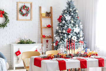 Beautiful table setting with Christmas decorations in living room