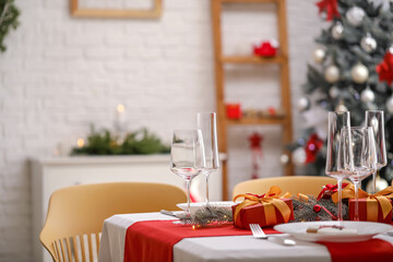 Beautiful table setting with Christmas decorations in living room