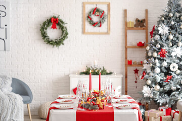Beautiful table setting with Christmas decorations in living room
