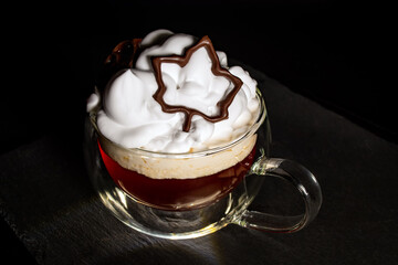 maple leaf, printed with chocolate on a 3D printer, on a cup of coffee
