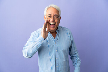 Middle age Brazilian man isolated on purple background shouting with mouth wide open