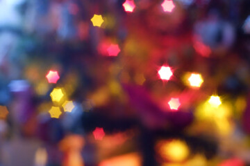 Yellow red christmas lights bokeh in the form of six-pointed stars background