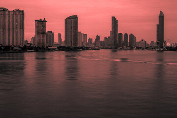 Blurred abstract background of high-rise buildings built by the river, lit at night, the distribution of residences of today's capital so