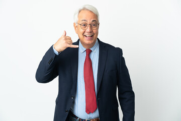 Middle age Brazilian business man isolated on white background making phone gesture. Call me back...
