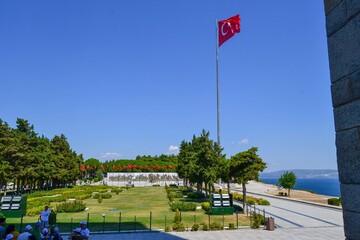 06.08.2018. Canakkale. Turkey. Turkish flag and monument of martyrs during sunny day and bright blue sky.