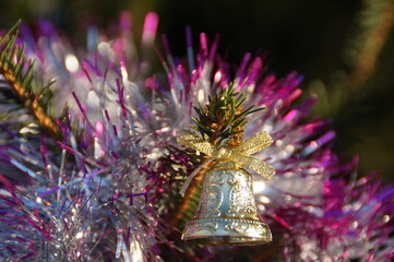 Festively decorated Christmas tree with bright tinsel, toys and garlands
