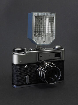 Old retro film camera with flash on a dark background. Camera. Antique