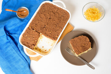 step-by-step recipe for the holiday of Hanukkah, a traditional sweet Kugel pie with noodles and custard, shortbread cocoa crumbs on top. on a light background in a baking dish