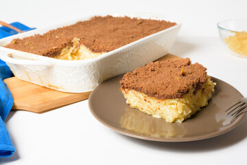 step-by-step recipe for the holiday of Hanukkah, a traditional sweet Kugel pie with noodles and custard, shortbread cocoa crumbs on top. on a light background in a baking dish