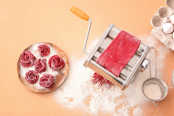 Pasta maker with dough on color background
