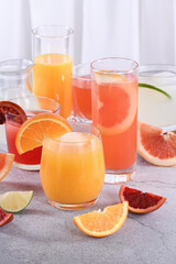 Refreshing freshly squeezed orange juice among fresh detox citrus juices from Sicilian orange, grapefruit, lime