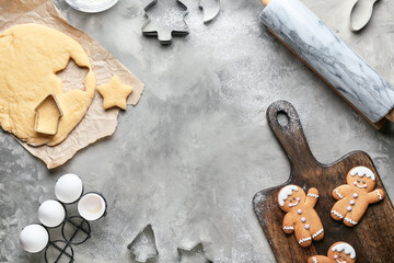 Fresh dough for gingerbread cookies and cutters on grunge background