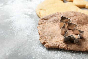 Fresh dough for gingerbread cookies and cutter on table