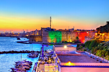 The famous Aragonese Castle in Taranto, Puglia, Italy, illuminated with italian flag colours on a...