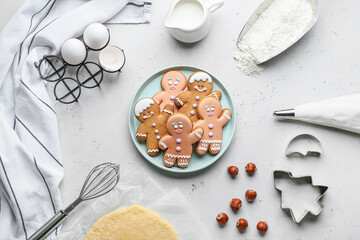 Tasty gingerbread cookies with ingredients on white background